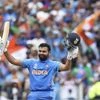 India's Rohit Sharma raises his bat and helmet to celebrate scoring a century