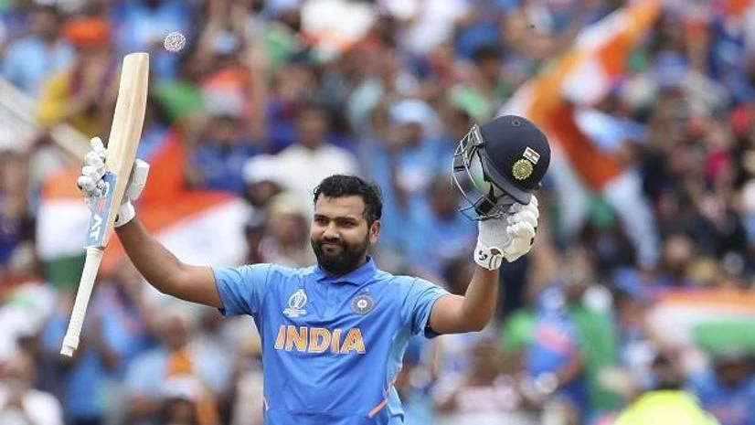 India's Rohit Sharma raises his bat and helmet to celebrate scoring a century India's Rohit Sharma raises his bat and helmet to celebrate scoring a century