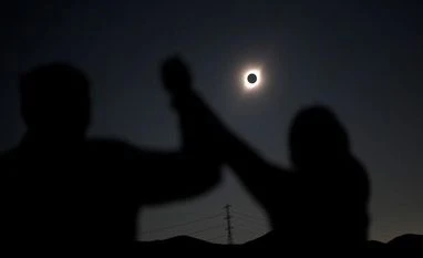 Solar eclipse: Odisha govt announces holiday for schools, colleges People react while observing a solar eclipse at Incahuasi, Chile