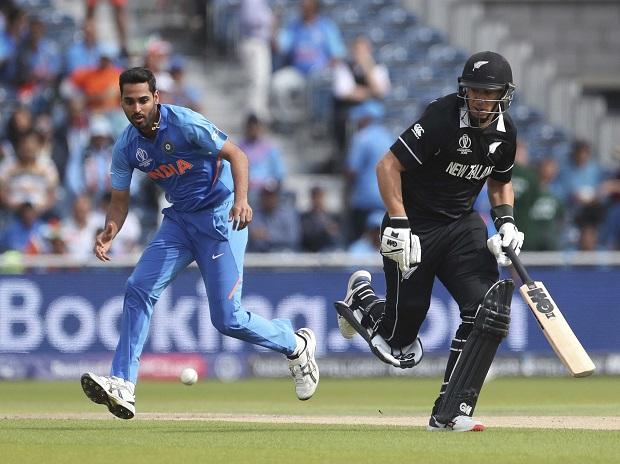India's Bhuvneshwar Kumar, left, runs to field the ball after a shot played by New Zealand's Tom Latham India's Bhuvneshwar Kumar, left, runs to field the ball after a shot played by New Zealand's Tom Latham
