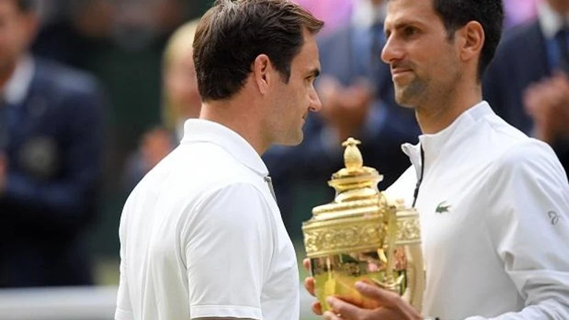 Djokovic(with the cup) and Federer after the final Djokovic(with the cup) and Federer after the final