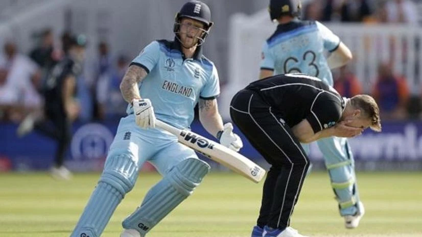 New Zealand's James Neesham, center, reacts as England's Jos Buttler, left, and Ben Stokes run between the wickets to score during the Cricket World Cup final match between England and New Zealand at Lord's cricket ground: Photo: AP/PTI London: New Zealand's James Neesham, center, reacts as England's Jos Buttler, left, and Ben Stokes run between the wickets to score during the Cricket World Cup final match between England and New Zealand at Lord's cricket ground: Photo: AP/PTI Photo