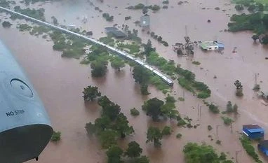 Mumbai rains: NDRF rescues 500 stranded passengers from Mahalaxmi Express A birds eye view shows Mahalaxmi Express bound for Kohlapur from Mumbai stranded following heavy monsoon rain near Badlapur in Thane district | Photo: PTI