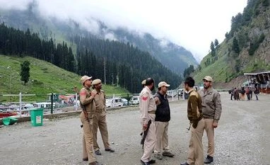 Amarnath Yatra temporarily suspended as rain lashes Kashmir valley Indian policemen stand guard at a base camp for a Hindu pilgrimage to the holy cave of Amarnath, where Hindu worship an ice stalagmite that they believe to be the symbol of Lord Shiva, near Pahalgam, in the Kashmir region