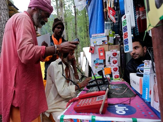 Hindu pilgrims make calls at a stall run by a Kashmiri Muslim before their journey towards the holy cave of Amarnath Hindu pilgrims make calls at a stall run by a Kashmiri Muslim before their journey towards the holy cave of Amarnath
