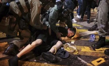 Protesters hold 'Free Hong Kong' signs, demand boycott of Communist Party Hong Kong: Hong Kong police officers detain a protester on the streets of Hong Kong on Sunday, July 28, 2019. (AFP/PTI)