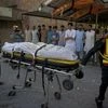 Pakistani rescue workers load a dead body of plane crash victim into an ambulance at a hospital in Rawalpindi, Pakistan.  A Pakistani military plane on a training flight crashed into homes near the garrison city of Rawalpindi before dawn on Tuesday,