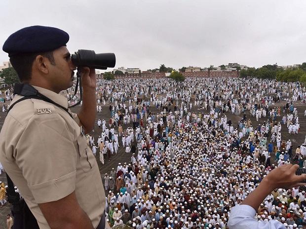 A policeman keeps vigil as people gather at an Eidgah in Bhopal to offer prayers A policeman keeps vigil as people gather at an Eidgah in Bhopal to offer prayers