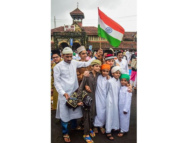 Children hold the Tricolour as they pose for a photograph during Eid al-Adha celebrations at Bandra station Children hold the Tricolour as they pose for a photograph during Eid al-Adha celebrations at Bandra station