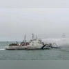 Indian Coast Guard personnel douse the fire that broke out at Offshore Support Vessel 'Coastal Jaguar' off the coast of Visakhapatnam, Monday. The 29-member crew reportedly jumped in the water to save themselves and abandon the burning vessel. 28 of Vizag Ship