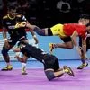 Gujarat Fortune Giants (In Red) and Telugu Titans players in action during their match at 7th season of Pro-Kabaddi League