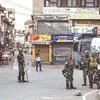 Security personnel stand guard during restrictions following the abrogation of the provisions of Article 370 in Srinagar