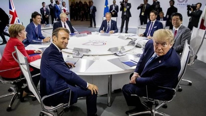 G7 Summit, French President Emmanuel Macron, center left, and President Donald Trump, center right, participate in a G-7 Working Session on the Global Economy, Foreign Policy, and Security Affairs the G-7 summit in Biarritz, France, Sunday, Aug. 25, 2019. Also