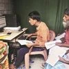 People checking their names on the final NRC list at a DTP centre of Buraburi Bazar, in Morigaon, Assam	Photo: PTI