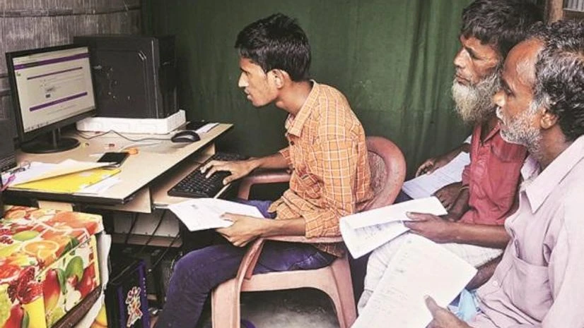 People checking their names on the final NRC list at a DTP centre of Buraburi Bazar, in Morigaon, Assam Photo: PTI People checking their names on the final NRC list at a DTP centre of Buraburi Bazar, in Morigaon, Assam Photo: PTI