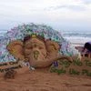 Sand artist Sudarsan Pattnaik creates a sand sculpture of lord Ganesha with a messges 'Say No to Single Use Plastic and Save our Environment ', ahead of Ganesh Chaturthi festival, at Puri beach of Odisha