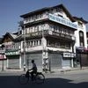 A man rides a bicycle past the closed shops and hotels during restrictions, after scrapping of the special constitutional status for Kashmir 	Photo: Reuters/File