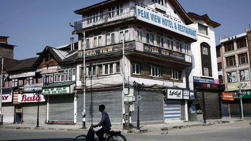 A man rides a bicycle past the closed shops and hotels during restrictions, after scrapping of the special constitutional status for Kashmir Photo: Reuters/File A man rides a bicycle past the closed shops and hotels during restrictions, after scrapping of the special constitutional status for Kashmir Photo: Reuters/File
