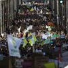 Thousands crowd main De la Loi street as they march during a climate protest in Brussels, Friday, Sept. 20