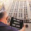 Demonstrators hold signs as part of a protest in support of impeachment hearings in New York, on Thursday 	PHOTO: Reuters