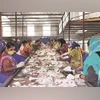 Women workers at one of the facilities segregating waste Women workers at one of the facilities segregating waste
