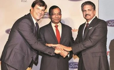 Jim Farley, president of Ford’s new businesses, with M&M MD Pawan Goenka and Mahindra Group Chairman Anand Mahindra at a news conference in Mumbai. (Photo: PTI) Jim Farley, president of Ford’s new businesses, with M&M MD Pawan Goenka and Mahindra Group Chairman Anand Mahindra at a news conference in Mumbai. (Photo: PTI)