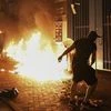 Protesters throw petrol bomb outside the Tsuen Wan police station in Hong Kong, Wednesday, Oct. 2, 2019. Holding up posters saying "Don't shoot our kids," Hong Kong residents and schoolmates of a teenage demonstrator shot at close range in the chest
