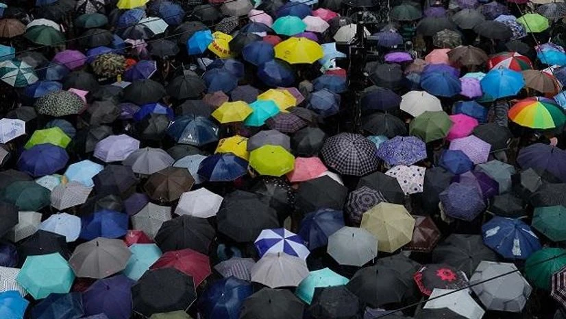 Protesters holding umbrellas take part in a march in Hong Kong, Sunday, Oct. 6, 2019. A group of pro-democracy Hong Kong legislators filed a legal challenge against the government's use of a colonial-era emergency law to criminalize the wearing of ma Protesters holding umbrellas take part in a march in Hong Kong, Sunday, Oct. 6, 2019. A group of pro-democracy Hong Kong legislators filed a legal challenge against the government's use of a colonial-era emergency law to criminalize the wearing of ma