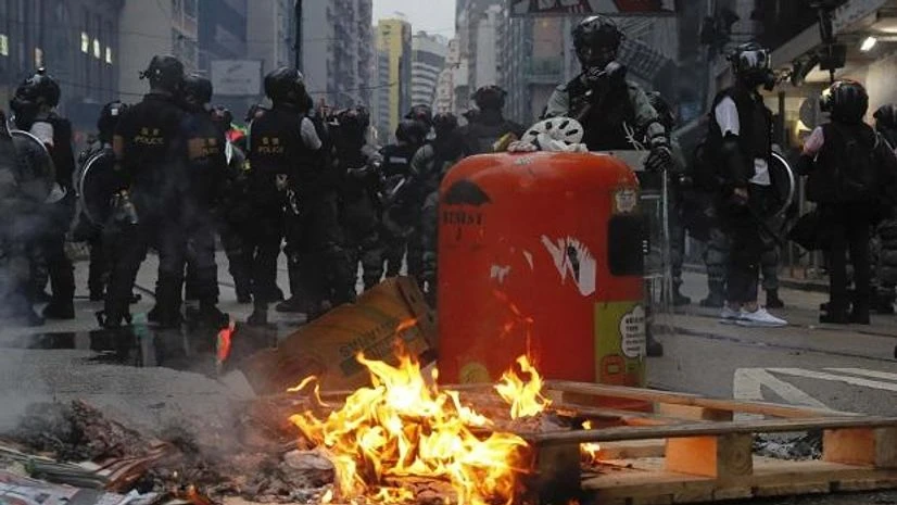 Hong Kong, Hong Kong protests Hong Kong: Police stand near fire made by protestors in Hong Kong (Photo: AP/PTI)
