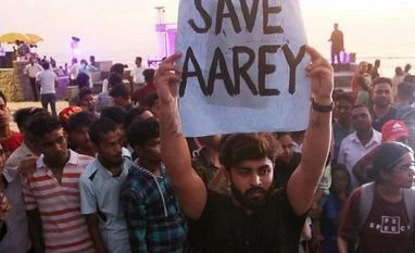 After chopping 2,141 trees in Aarey, Metro says will abide by SC order Mumbai: An activist holds a placard during a protest against cutting down of trees for a proposed metro car shed project at Aarey Colony in Mumbai, Sunday, Oct. 6, 2019. (PTI Photo)