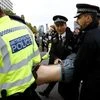 Police officers detain an activist at Westminster Bridge during the Extinction Rebellion protest in London, Britain. Photo: Reuters