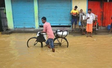 Assam flood situation worsens; 1 more dead, over 253,000 people affected Dimapur: A cyclist wades through a flooded area following heavy monsoon rain, in Dimapur, Nagaland, Monday, Oct. 7, 2019. (PTI Photo)(