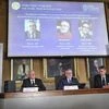 Stockholm: Goran K Hansson, centre, Secretary General of the Royal Swedish Academy of Sciences, and academy members Mats Larsson, left, and Ulf Danielsson, announce the winners of the 2019 Nobel Prize in Physics, during news conference at the Royal S