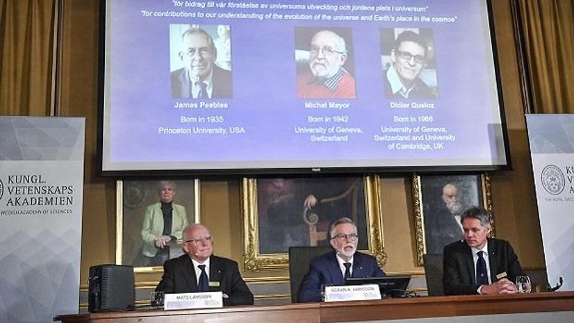 Stockholm: Goran K Hansson, centre, Secretary General of the Royal Swedish Academy of Sciences, and academy members Mats Larsson, left, and Ulf Danielsson, announce the winners of the 2019 Nobel Prize in Physics, during news conference at the Royal S Stockholm: Goran K Hansson, centre, Secretary General of the Royal Swedish Academy of Sciences, and academy members Mats Larsson, left, and Ulf Danielsson, announce the winners of the 2019 Nobel Prize in Physics, during news conference at the Royal S