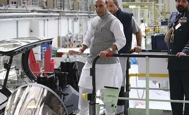 Rajnath Singh calls on French defence industry to make in India Bordeaux: Indian Defense Minister Rajnath Singh puts his foot on a Rafale jet fighter in Merignac, near Bordeaux, southwestern France, Tuesday, Oct. 8, 2019. Rajnath Singh formally accepts the first Rafale fighter jet after India had signed a deal w