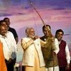 New Delhi: Prime Minister Narendra Modi prepares to shoot an arrow at the effigy of demon-king Ravana (Ravana) as Delhi BJP chief Manoj Tiwari (L) looks on during Dussehra celebrations, organised by Dwarka Sri Ram Leela Society at Dwarka in New Delhi