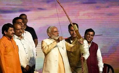 Work towards women empowerment, ensure their dignity: PM Modi on Dussehra New Delhi: Prime Minister Narendra Modi prepares to shoot an arrow at the effigy of demon-king Ravana (Ravana) as Delhi BJP chief Manoj Tiwari (L) looks on during Dussehra celebrations, organised by Dwarka Sri Ram Leela Society at Dwarka in New Delhi
