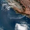 This satellite image from the National Oceanic and Atmospheric Administration (NOAA) shows a plume of smoke from the Saddleridge wildfire streaming out over the Pacific Ocean