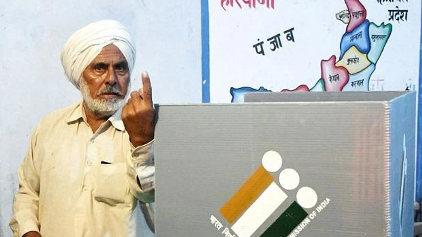 Haryana assembly elections 2019, voter, voting First voter Ajjaib Singh shows his finger after casting vote in Khurkara polling station in Ambala constituency, Monday, Oct 21, 2019