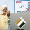 First voter Ajjaib Singh shows his finger after casting vote in Khurkara polling station in Ambala constituency