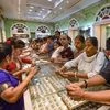 Women buy gold ornaments on the occasion of 'Dhanteras' festival at a shop in Kolkata
