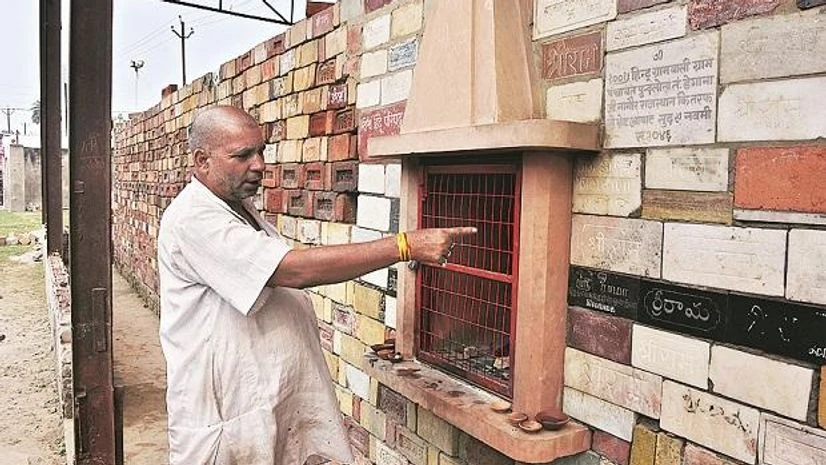A volunteer at the workshop points to the bricks collected from across India for a Ram temple A volunteer at the workshop points to the bricks collected from across India for a Ram temple