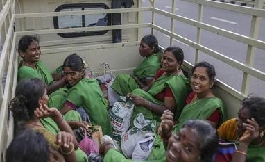 Women's role in labour force declining due to education, migration: Govt Workers depart in a truck from the Daimler India Commercial Vehicles Pvt. manufacturing facility in the Oragadam district of Chennai. (Photo source: Bloomberg)