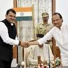 Newly-sworn in Chief Minister of Maharashtra Devendra Fadnavis shakes hands with his Deputy Chief Minister Ajit Pawar, in Mumbai, Saturday | PTI Photo