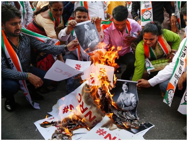 NCP leader Jitendra Awhad with party supporters burns posters in Thane NCP leader Jitendra Awhad with party supporters burns posters in Thane