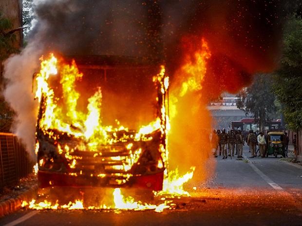 A DTC bus set on fire by anti-Citizenship Act protestors at Mathura Road, in New Delhi A DTC bus set on fire by anti-Citizenship Act protestors at Mathura Road, in New Delhi