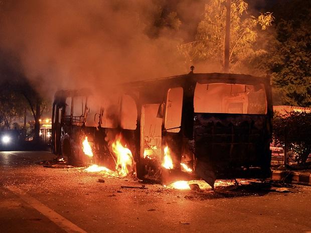 A DTC bus set on fire following protests near Mathura Road, in New Delhi A DTC bus set on fire following protests near Mathura Road, in New Delhi