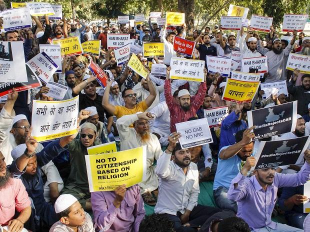 Protestors hold placards against Citizenship Amendment Act (CAA), in Ahmedabad Protestors hold placards against Citizenship Amendment Act (CAA), in Ahmedabad