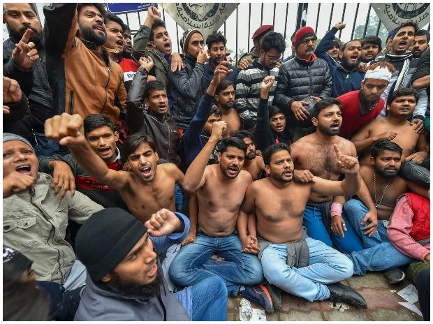 Students protest shirtless at the campus against Delhi Police's action on students at Jamia Millia Islamia yesterday, in New Delhi Students protest shirtless at the campus against Delhi Police's action on students at Jamia Millia Islamia yesterday, in New Delhi