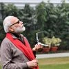 Prime Minister Narendra Modi looks towards the sky to catch a glimpse of an annular solar eclipse,  in New Delhi